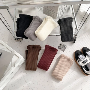 Detailed texture of thick ribbed knit leg warmers in seven various winter colors