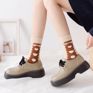 Detail of khaki platform derby shoes with brown bear pattern polka dot socks