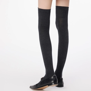 Close-up of slim-fit dark gray over-knee socks in high-quality fine knit fabric