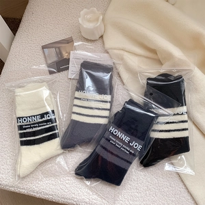 Detail of four-pack warm knit socks with stripe pattern in independent zipper bags