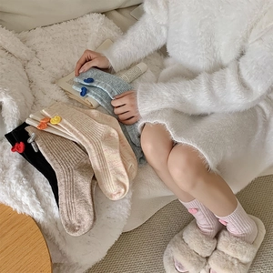 Gros plan sur des chaussettes en laine côtelée avec de jolis patchs en cœur au crochet