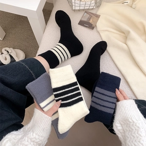 Detail of striped knitted crew socks in warm thick fabric for autumn winter style