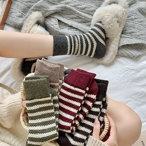 Detail of warm striped wool crew socks in retro colors for winter comfort and style