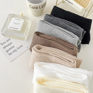 Collection of rib-knit leg warmers in various neutral colors for a cozy autumn look