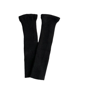 Pair of thick black ribbed knit leg warmers in a minimalist style for winter wear