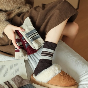 Detail of warm wool blend striped mid-calf socks with ribbed cuffs for winter