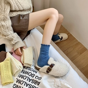Detailed view of women's thick wool socks with ruffled cuffs in various soft colors