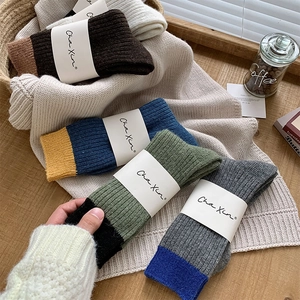 Detailed close-up of ribbed wool blend socks in four assorted color combinations