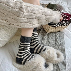Close-up of thick knitted wool striped socks for women featuring cozy winter textures