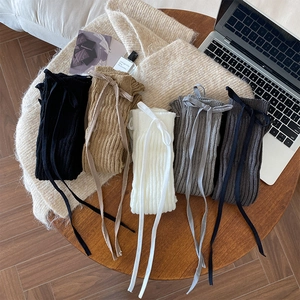 Detailed knit leg warmers in five colors with cross ribbon ties and ribbed texture