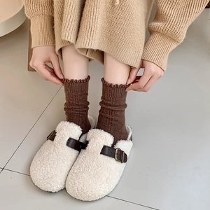 Fleece winter clogs with leather strap and metal buckle paired with ruffled warm socks