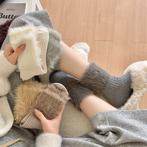 Detailed view of thick knit socks featuring premium faux fur cuffs and ribbed texture