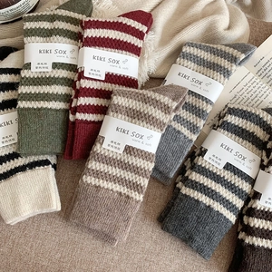 Winter wool socks in retro colors with thick striped texture and cozy thermal knit detail