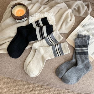 Detailed knit texture of wool stripe socks in black, white and grey colors