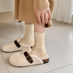 Creamy wool socks with thick fleece lining and cozy shearling mules for winter
