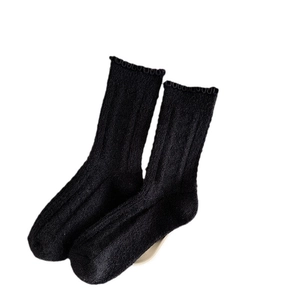 Thick black wool socks with ruffled edges and vertical ribbed texture for winter warmth