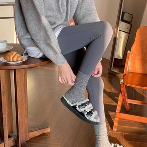 Detailed look at wool heart embossed crew socks with gray leggings and stylish slippers