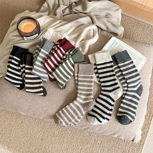 Close-up of thick striped wool socks in autumn colors with warm knit texture