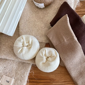Close-up of thick ribbed knit crew socks in earthy tones with soft terry texture