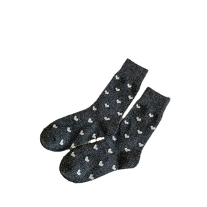 Deep grey mid-calf wool socks featuring white heart jacquard and ribbed elastic cuffs