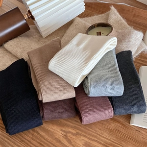 Cozy thick rib-knit calf socks in multiple colors displayed on a wooden table surface