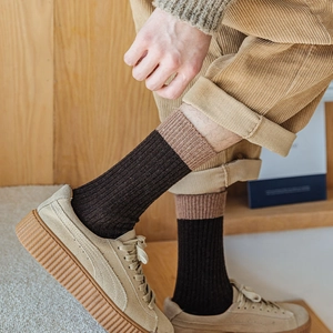 Thick wool socks for men featuring contrast color cuffs and vertical ribbed knit texture