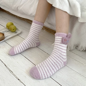 Detailed view of striped coral fleece socks with purple ears and soft plush texture