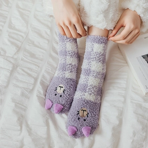 Close-up of purple coral fleece socks with cute cartoon animal faces and 3D ears