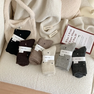Detailed set of six thick vintage polka dot wool socks in various warm autumn colors