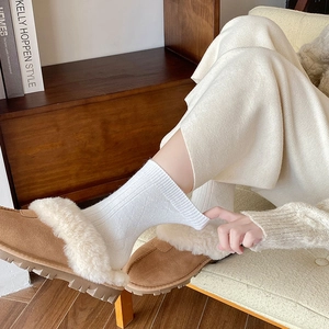 Detailed view of warm cashmere socks with diamond knit pattern and plush lined slippers
