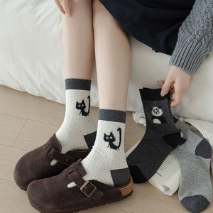 Detailed view of cute cat motif crew socks with ribbed cuffs and contrast heel