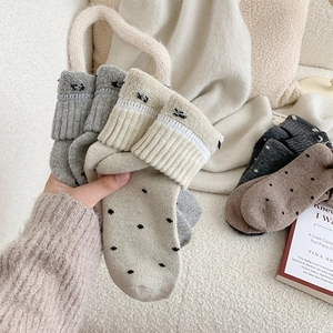 Detailed texture of thick wool socks with polka dots and eye embroidery for winter