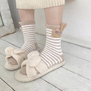 Detail of coral fleece striped socks with cute ears and plush bow open-toe slippers