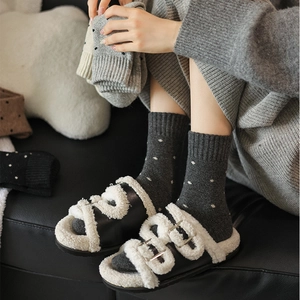 Detail of wool blend polka dot socks paired with cozy faux fur lined slippers