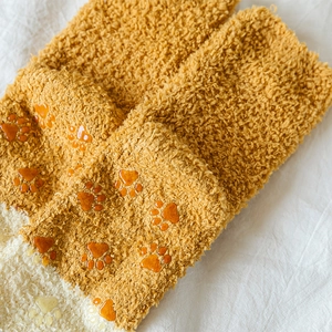 Detail of coral fleece sock with non-slip silicone cat paw pads on the sole