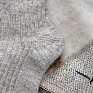 Close-up of thick grey wool blend socks showing warm ribbed knit texture and soft material