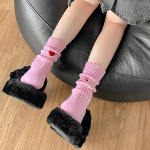 Pink rib-knit crew socks with heart embroidery and Follow your heart text detail