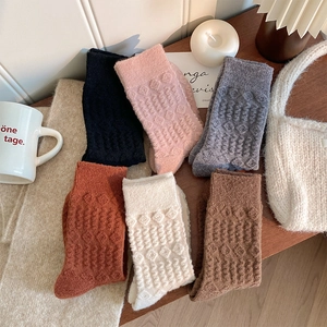 Detailed close-up of thick knitted wool socks with textured relief wave patterns in 6 colors