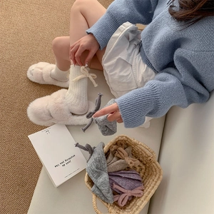 Cozy wool knit mid-calf socks for women featuring sweet heel bows in various soft colors