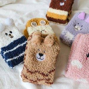 Detail of coral fleece striped socks with cute 3D ears and soft embroidered animal faces