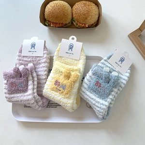 Detail of coral fleece striped socks with cute 3D ears and high-quality embroidery