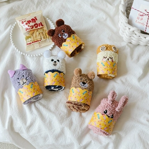 Detail of coral fleece socks with 3D animal ears in a rolled gift set packaging