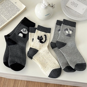 Detail of three pairs of Japanese style cotton socks with cute cat and panda patterns