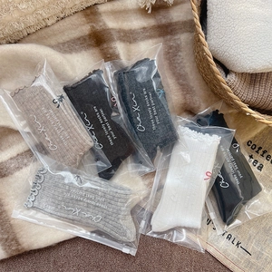 Detail of wool socks set in assorted colors with ruffled cuffs and zip packaging
