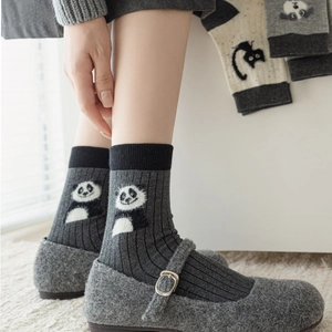 Close-up of dark grey ribbed socks with cute panda pattern and grey Mary Jane shoes