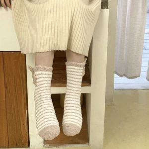 Detail of coral fleece striped socks with cute 3D animal ears in warm beige and brown