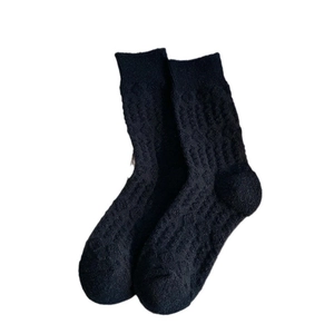 Black wool blend crew socks with embossed wave pattern and thick thermal texture