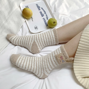 Detail of soft coral fleece striped thermal socks with small ear design and side label