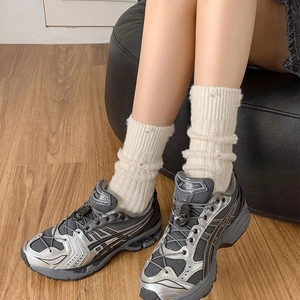 Vintage style grey mesh sneakers paired with thick white distressed knit socks