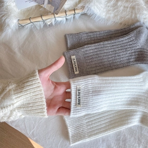 Detail of ribbed knit texture and elastic cuff on stylish cotton socks in grey and white